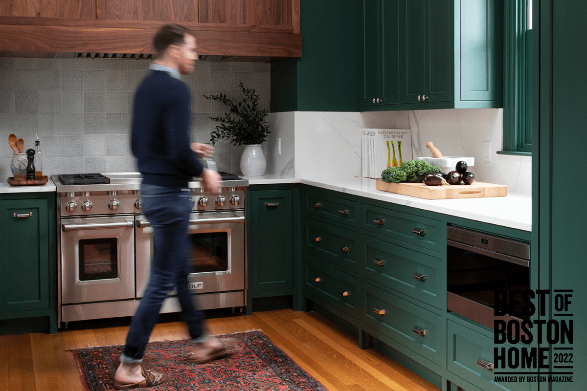remodeled-kitchen-with-man-walking-and-green-cabinets-in-boston-min
