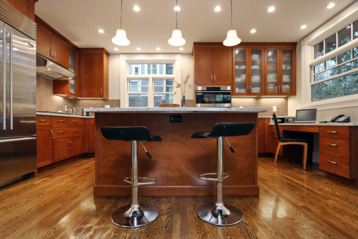 oak wood kitchen remodel with two barstools at kitchen island in somerville, MA