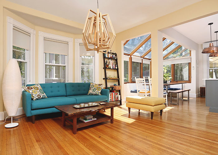 seating area next to kitchen remodel in lexington ma with colorful turquoise couch