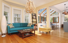 architecturally designed living room with teal couch and hardwood floors