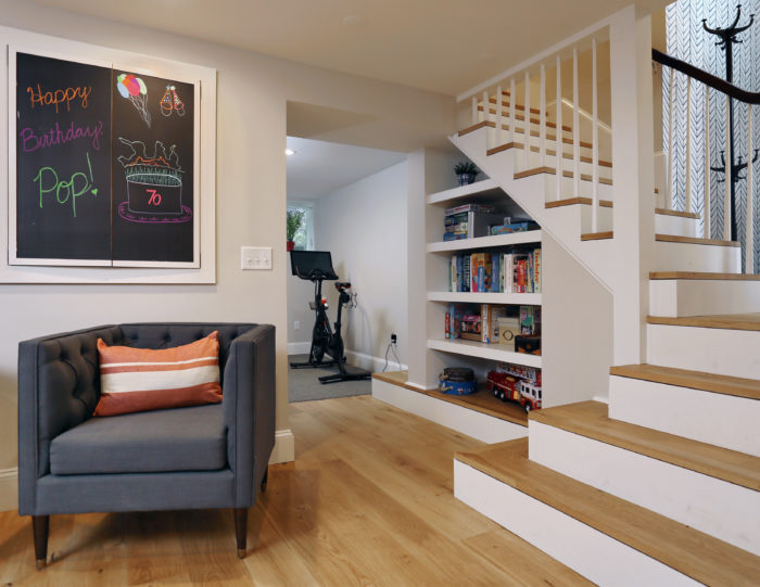 finished basement next to staircase and wood flooring