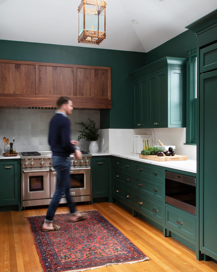 remodeled-kitchen-with-man-walking-and-green-cabinets-in-boston