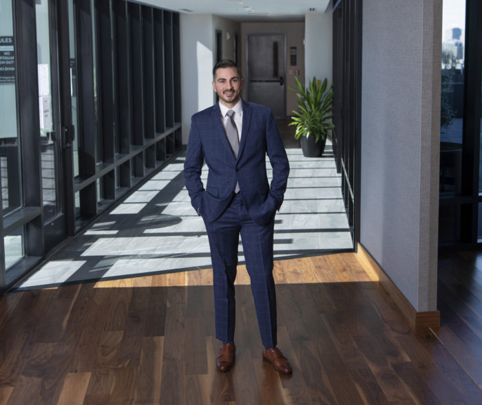 Brian Caluori in suit in hallway