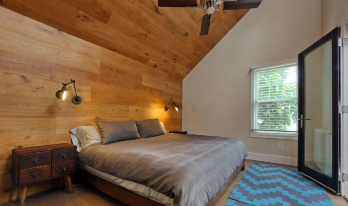 second story addition bedroom with king bed and angled roof in boston