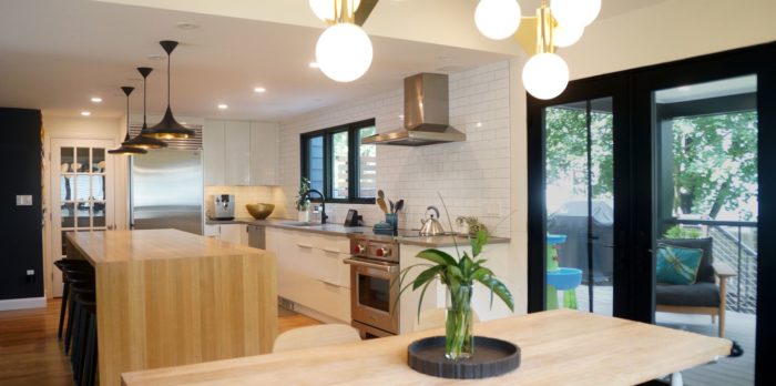 modern first floor remodel in boston dining room and wood waterfall kitchen island and white tile backsplash