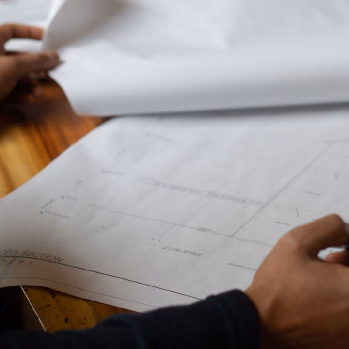 professional architect working on blueprints in boston design build architect firm