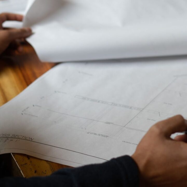 professional architect working on blueprints in boston design build architect firm