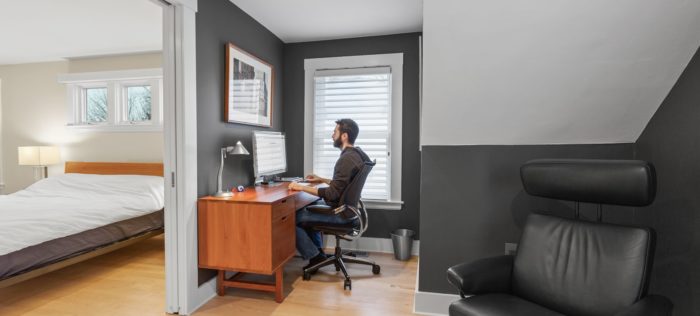 man working at desk in home office in boston