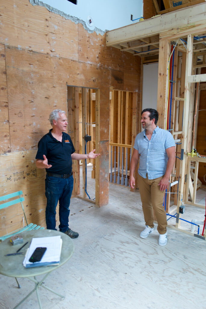 NEDC Architectural Design Build project manager Paul Ledoux taking Aurelian (Oz) Dallaserra through a whole home gut remodel in Cambridge, explaining its benefits.
