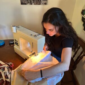 A photo of Emerson Sprague sewing